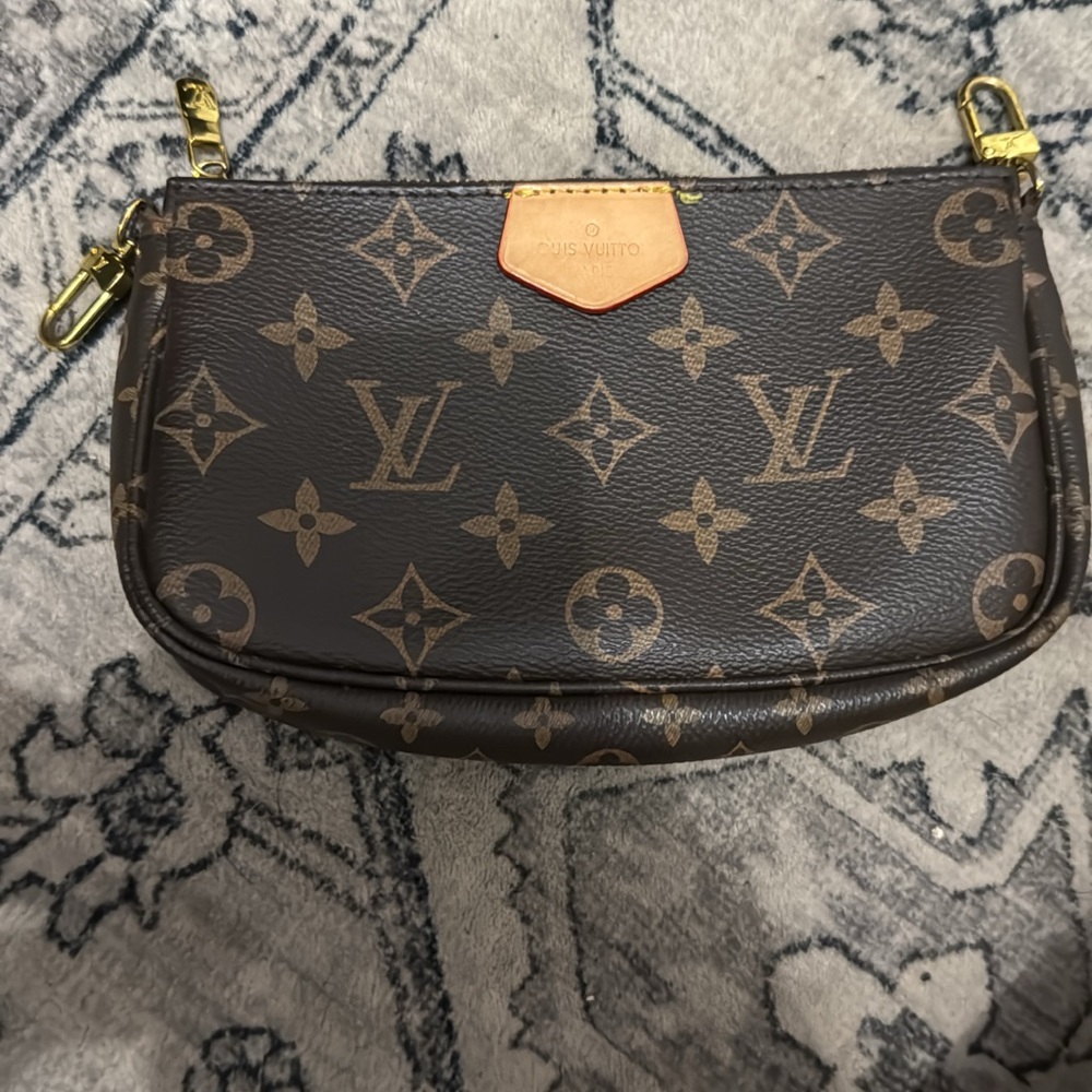 Louis Vuitton Brown and Tan Monogram clutch.